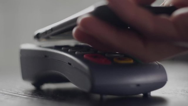 Close Up shot of person using mobile payment PayPass, Contactless payment