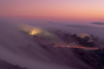 Lights through the mountain fog at sunset