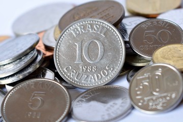 Brazil's 10 cruzados coin on top of coins from other countries