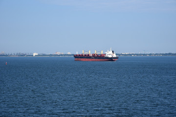 Fototapeta premium Cargo ship waiting on the road to enter port of Norfolk, Virginia. 