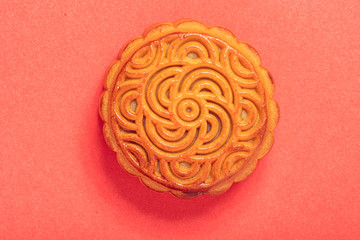 Chinese mooncake isolated on red background by top view.