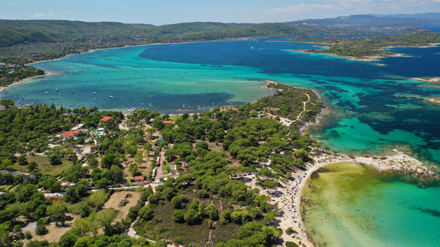 Aerial drone panoramic photo of iconic bay with turquoise frozen waves of Vourvourou in Sithonia Peninsula, Halkidiki, North Greece © aerial-drone
