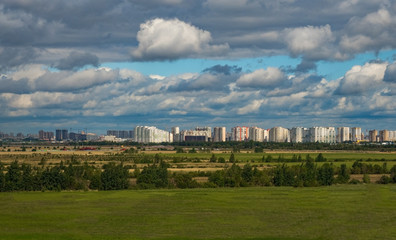 Fototapeta na wymiar Residential area on the outskirts of the city. City on the horizon.