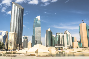 Fototapeta na wymiar Qasr Al Hosn fort museum in front of skyscrapers in Abu Dhabi, UAE
