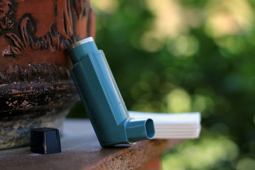 Medicine and health concept: Blue inhaler for treat asthma attack.