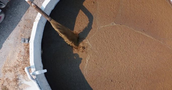 Aerial view of a pipe is pumping organic cow  manure compost  used for agricultural soil cultivation and for biogas, renewable sources of energy.