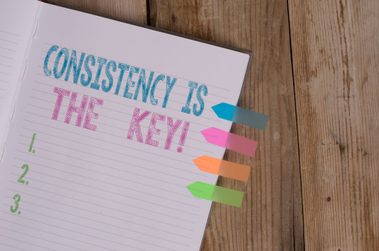 Text sign showing Consistency Is The Key. Business photo text by Breaking Bad Habits and Forming Good Ones Striped note book four colored arrow banners reminder wooden background