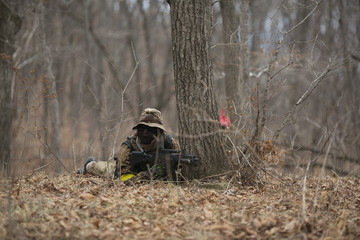 Active military exercises in the forest. Shootout army in the autumn forest. Training airsoft teams in Russia.