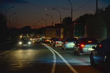 Night traffic jam on the two-way intercity road caused by an accident. Ukraine.
