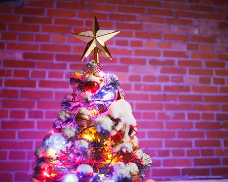 Christmas tree against brick wall background