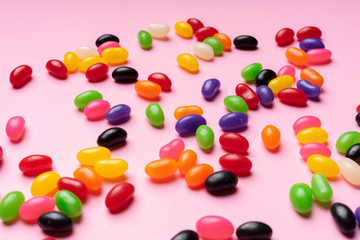 colourful jelly beans candies pink background Top view