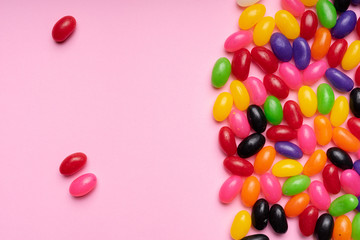 colourful jelly beans candies pink background Top view