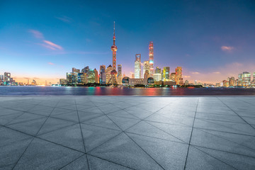 Empty square floor and modern city scenery at night in Shanghai,China.