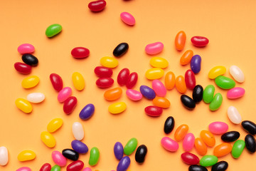 colourful jelly beans candies orange background Top view