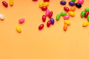 colourful jelly beans candies orange background Top view