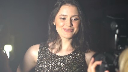 Young female celebrity posing front of photographers, fame attention, mass media