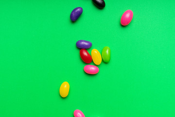 colourful jelly beans candies green background Top view