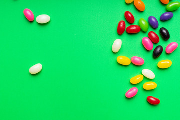 colourful jelly beans candies green background Top view