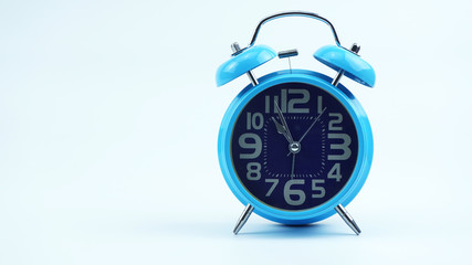Blue Alarm clock face beginning of time 11.00 am. on white background, Copy space for your text, Time concept..