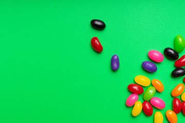 colourful jelly beans candies green background Top view