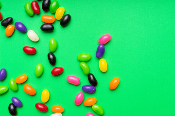 colourful jelly beans candies green background Top view