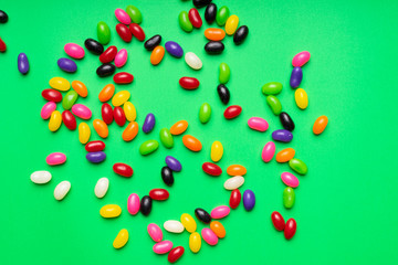 colourful jelly beans candies green background Top view