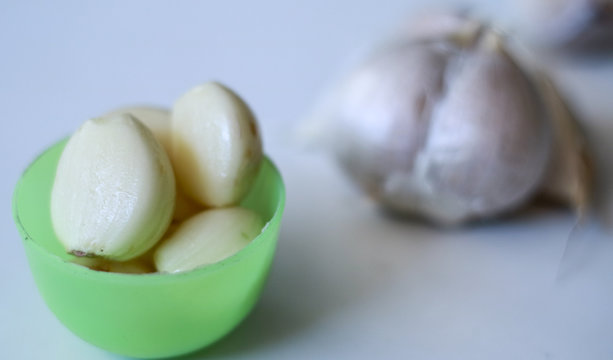 Peeled garlic on white background.