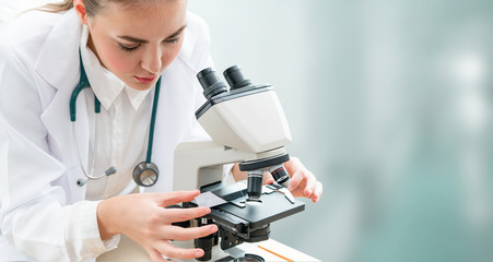 Scientist researcher using microscope in laboratory. Medical healthcare technology and...