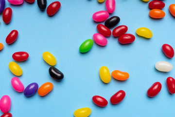 colourful jelly beans candies blue background Top view