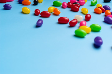 colourful jelly beans candies blue background Top view