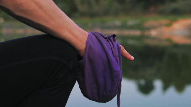 Close-up, Reading Mantra on the Lake, Man's Hand Holding Pouch with Rosary