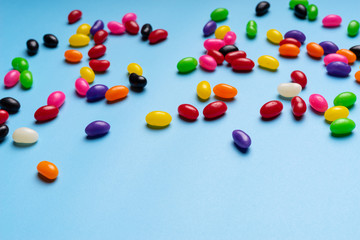 colourful jelly beans candies blue background Top view