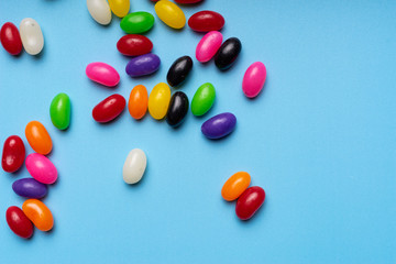 colourful jelly beans candies blue background Top view