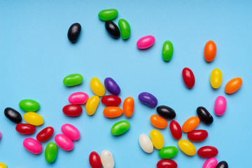 colourful jelly beans candies blue background Top view