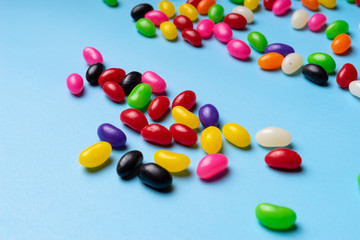 colourful jelly beans candies blue background Top view