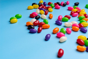 colourful jelly beans candies blue background Top view