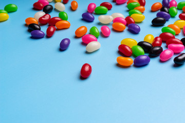 colourful jelly beans candies blue background Top view
