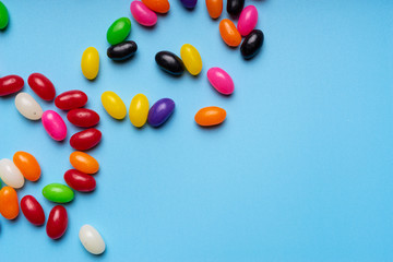 Obraz premium colourful jelly beans candies blue background Top view