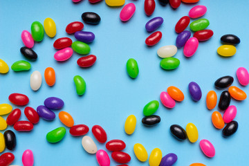 colourful jelly beans candies blue background Top view