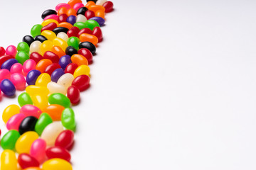 Obraz premium colorful jelly beans candies white background Top view