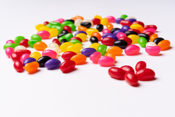Fototapeta na wymiar colorful jelly beans candies white background Top view