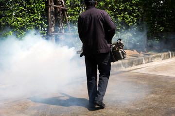 Man using smoke machine for pest control