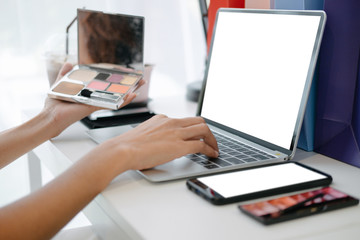 Mockup image of Beautiful woman shopping online with laptop and smartphone on online websites, mockup concept