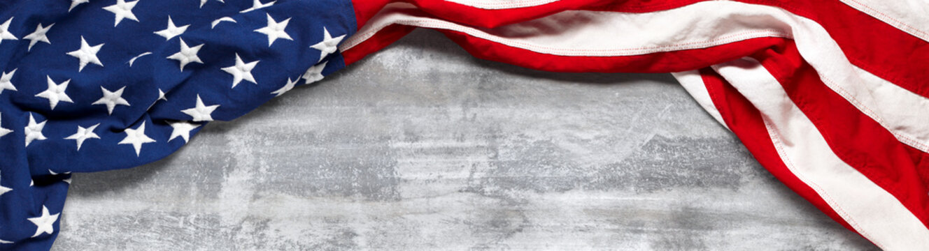 US American flag on worn white wooden background. For USA Memorial day, Veteran's day, Labor day, or 4th of July celebration. With blank space for text.