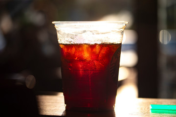 Starbucks cold brew on coffee shop table with sunny background.