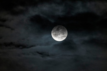 Naklejka na ściany i meble Full Moon hiding in the cloud
