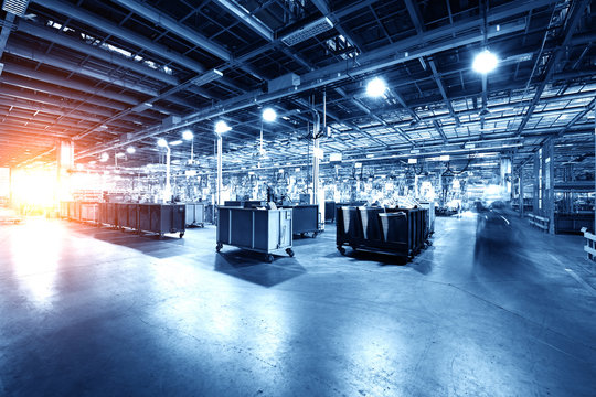 Modern Automatic Automobile Manufacturing Workshop. A Busy Car Production Line. Industrial Scenery Background.