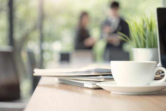 Close-up of coffee cup on table in meeting room