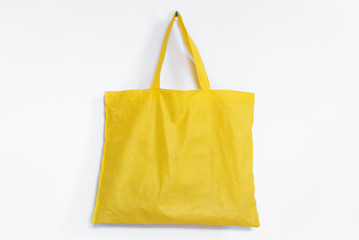 Yellow reusable fabric bag, on white background
