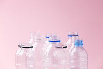 Set of empty plastic water bottles on pink background, chemical industry, eco recycle plastic material, zero waste concept, plastic ban